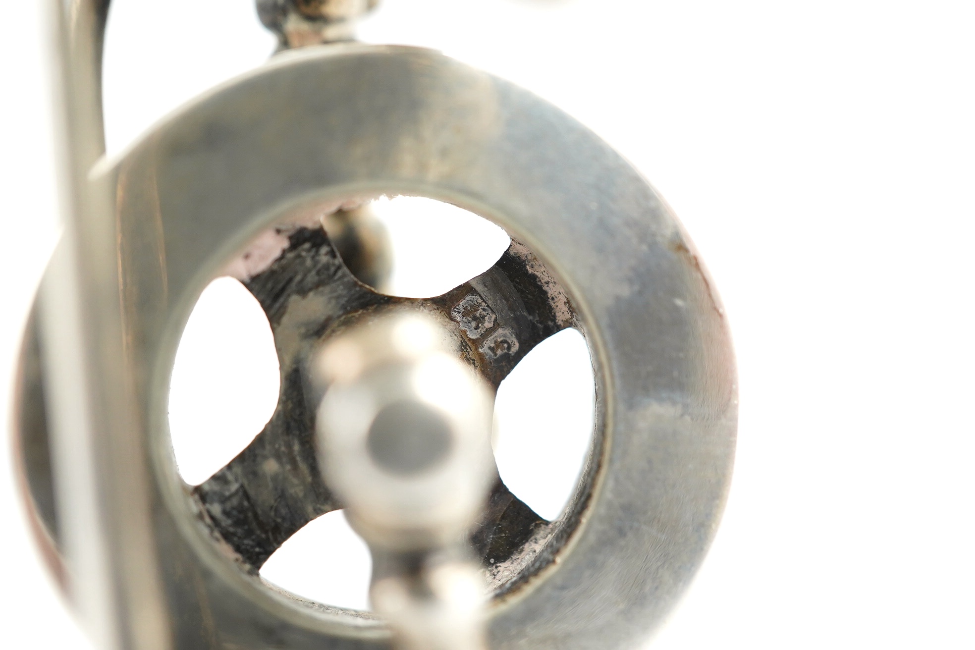 An Edwardian silver miniature articulated model spinning wheel, by Deakin and Francis Ltd, Birmingham 1905, 8.5cm and a cased set of coffee spoons, Sheffield 1936, with ‘bean’ terminals. Condition - fair